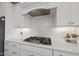 Modern kitchen features white cabinets, quartz countertops, and stainless steel range at 2244 Plowridge Rd, Fuquay Varina, NC 27526