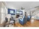 Inviting living room boasts hardwood floors, a stone fireplace, and a ceiling fan at 2244 Plowridge Rd, Fuquay Varina, NC 27526