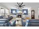 Bright living room featuring fireplace, hardwood floors, ceiling fan, and comfortable seating at 2244 Plowridge Rd, Fuquay Varina, NC 27526