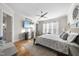 Serene main bedroom boasts hardwood floors, ceiling fan, and an entertainment center at 2244 Plowridge Rd, Fuquay Varina, NC 27526