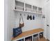 Well-organized mudroom features built-in bench with storage and coat hooks at 2244 Plowridge Rd, Fuquay Varina, NC 27526