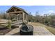 Outdoor patio with fire pit and covered pergola with swing and dining area at 2244 Plowridge Rd, Fuquay Varina, NC 27526