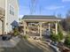 Charming outdoor covered patio featuring a wooden swing, dining area, and a hot tub nearby at 2244 Plowridge Rd, Fuquay Varina, NC 27526