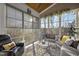 Bright sunroom with wood ceiling, floor-to-ceiling windows, and comfortable seating at 2244 Plowridge Rd, Fuquay Varina, NC 27526