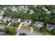 Aerial shot of a home with a green lawn, surrounded by mature trees in a quiet neighborhood at 229 Shillings Chase Dr, Cary, NC 27518