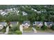Aerial view of a neighborhood with mature trees and well maintained lawns surrounding traditional homes with manicured yards at 229 Shillings Chase Dr, Cary, NC 27518