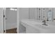 Bright bathroom with white cabinetry, solid surface counters, and tiled shower at 229 Shillings Chase Dr, Cary, NC 27518