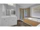 Bathroom featuring a double vanity, bathtub, and a glass-enclosed shower at 229 Shillings Chase Dr, Cary, NC 27518