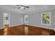 Large bedroom with hardwood floors, natural light, neutral paint colors, and an ensuite bathroom at 229 Shillings Chase Dr, Cary, NC 27518