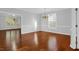 Spacious dining room with gleaming hardwood floors, elegant chandelier and plenty of natural light from large windows at 229 Shillings Chase Dr, Cary, NC 27518