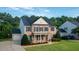 Traditional brick home with black shutters, gabled roof, and well-maintained lawn at 229 Shillings Chase Dr, Cary, NC 27518
