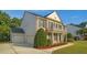 Charming two-story brick home featuring a spacious three-car garage and manicured landscaping at 229 Shillings Chase Dr, Cary, NC 27518