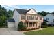 Charming brick home with black shutters, a three-car garage, and landscaped front yard at 229 Shillings Chase Dr, Cary, NC 27518