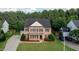 Spacious brick home with green lawn, black shutters, and a two-car attached garage at 229 Shillings Chase Dr, Cary, NC 27518