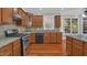 Updated kitchen featuring stainless steel appliances, granite counters, and hardwood floors at 229 Shillings Chase Dr, Cary, NC 27518
