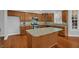 Kitchen with wooden cabinets, granite countertops, an island, and stainless steel appliances at 229 Shillings Chase Dr, Cary, NC 27518