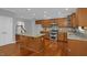 Well-equipped kitchen featuring a granite island, hardwood floors and stainless appliances at 229 Shillings Chase Dr, Cary, NC 27518