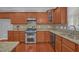 Updated kitchen with stainless steel appliances, granite countertops, and ample cabinet space at 229 Shillings Chase Dr, Cary, NC 27518