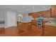 Well-equipped kitchen boasting stainless steel appliances, granite counters, and hardwood flooring at 229 Shillings Chase Dr, Cary, NC 27518