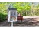 Community library box featuring an assortment of books for all ages, nestled in a green space at 229 Shillings Chase Dr, Cary, NC 27518