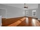 Neutral living room with a ceiling fan, hardwood floors, two large windows, and crown molding at 229 Shillings Chase Dr, Cary, NC 27518