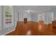 Spacious living room with a fireplace, built-in shelving, hardwood floors, and large windows at 229 Shillings Chase Dr, Cary, NC 27518