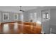 A spacious living room with hard wood floors, two large windows, and neutral paint colors at 229 Shillings Chase Dr, Cary, NC 27518