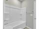 Clean bathroom with a shower-tub combo, white tile, and built-in shelves at 240 S Stonehaven Way, Clayton, NC 27527