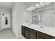 Bathroom featuring a double vanity with dark cabinets, white countertops and tile flooring at 240 S Stonehaven Way, Clayton, NC 27527