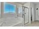 Bathroom featuring a glass enclosed shower, tub, and window with blinds at 240 S Stonehaven Way, Clayton, NC 27527
