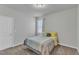 Comfortable bedroom with neutral walls, a window with curtains, and plush carpet flooring at 240 S Stonehaven Way, Clayton, NC 27527
