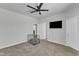 Bright bedroom featuring carpet, ceiling fan, TV, and a dog crate at 240 S Stonehaven Way, Clayton, NC 27527