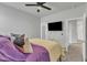 Bedroom showcasing a ceiling fan and a doorway offering a view of a hallway at 240 S Stonehaven Way, Clayton, NC 27527