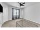Neutral bedroom with plush carpeting, a ceiling fan, and natural light from the window at 240 S Stonehaven Way, Clayton, NC 27527
