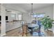 Open dining area with a round table, stylish chairs, and sliding glass doors leading to the outside at 240 S Stonehaven Way, Clayton, NC 27527