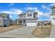 Charming two-story home featuring a covered front porch and a two-car garage at 240 S Stonehaven Way, Clayton, NC 27527