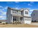 Charming two-story home featuring a covered front porch and a two-car garage at 240 S Stonehaven Way, Clayton, NC 27527