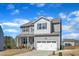 Charming two-story home featuring a covered front porch and a two-car garage at 240 S Stonehaven Way, Clayton, NC 27527
