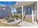 Cozy front porch with stylish seating and landscaped garden beds at 240 S Stonehaven Way, Clayton, NC 27527