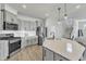 Updated kitchen featuring stainless steel appliances, gray cabinets and an island at 240 S Stonehaven Way, Clayton, NC 27527