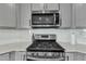 Modern kitchen features stainless steel gas range with a stylish tile backsplash at 240 S Stonehaven Way, Clayton, NC 27527