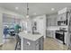 Bright kitchen with gray cabinets, stainless steel appliances, and an island with barstool seating at 240 S Stonehaven Way, Clayton, NC 27527