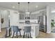 Modern kitchen featuring gray cabinets, stainless steel appliances, and a center island with seating at 240 S Stonehaven Way, Clayton, NC 27527