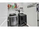Laundry room featuring a modern washer and dryer, storage shelves, and Laundry Room wall decor at 240 S Stonehaven Way, Clayton, NC 27527