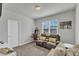 Cozy living room features sofa, arcade, and bright window at 240 S Stonehaven Way, Clayton, NC 27527