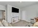 Living room with sofa, arcade game, TV, and storage at 240 S Stonehaven Way, Clayton, NC 27527