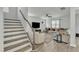 Beautiful staircase and living room with plush sofa, accent chairs, and ceiling fan at 240 S Stonehaven Way, Clayton, NC 27527