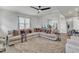 Bright and airy living room features a large sectional and views into the dining area at 240 S Stonehaven Way, Clayton, NC 27527