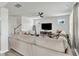 Open-concept living room features a comfy sofa, television, and neutral color palette at 240 S Stonehaven Way, Clayton, NC 27527