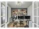 Well-lit home office with multiple monitors and unique wall decor at 240 S Stonehaven Way, Clayton, NC 27527